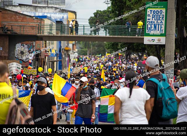 Demonstrators carry and wave Colombian flags during riots and lootings across the city of Cali as demonstrators gather during the first day of anti-government...