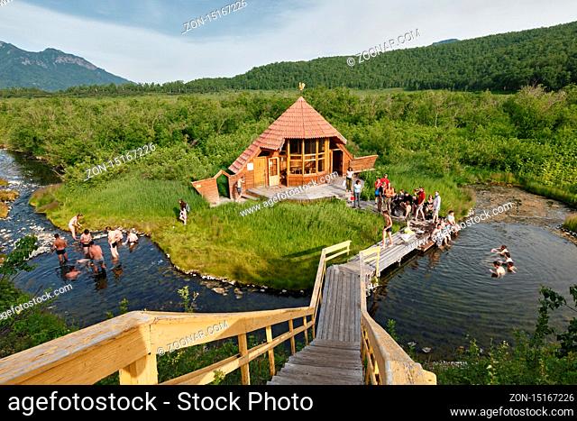 NALYCHEVO, KAMCHATKA, RUSSIA - JULY 11, 2014: Goryacherechensky group hot springs in nature park Nalychevo, tourists swimming in the natural thermal pools