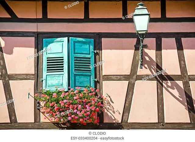 Boersch (Bas-Rhin, Alsace, France) - Exterior of old half-timbered house with flowers and lamp