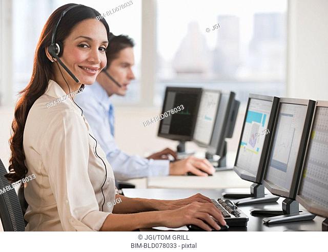 Hispanic businesswoman working on computer