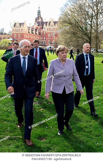 German Chancellor Angela Merkel (CDU) and Saxony's Prime MInister Stanislaw Tillich (CDU) walk through the Fuerst Pueckler park during the closure of the 44th...