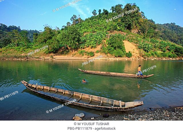 tribal people are carring goods by boat on the Sangu river at Tindu Bandarban, Bangladesh
