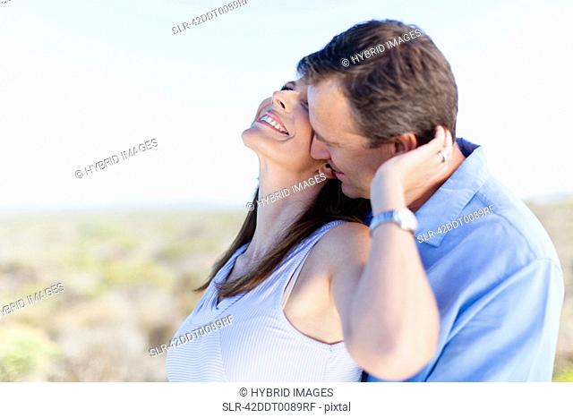 Smiling couple hugging outdoors