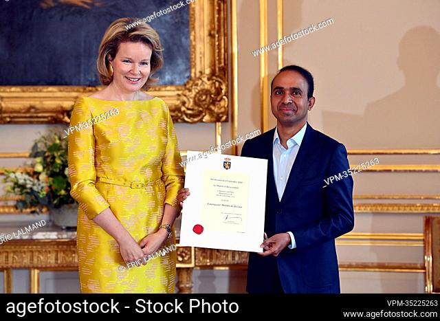 Queen Mathilde of Belgium and Said Meer of Meer Couture pictured during a royal reception with the newly appointed suppliers holding a 'Royal warrant of...