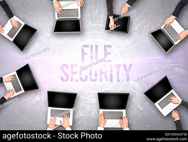 Group of people in front of a laptop with FILE SECURITY insciption, web security concept