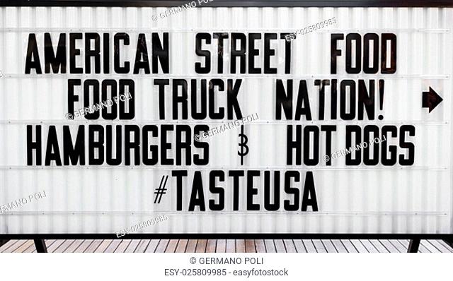Signboard indicating an American street food here nearby