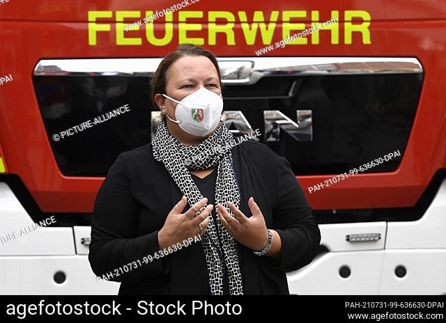 31 July 2021, North Rhine-Westphalia, Leverkusen: North Rhine-Westphalia's Environment Minister Ursula Heinen-Esser thanks the site fire brigade for their...