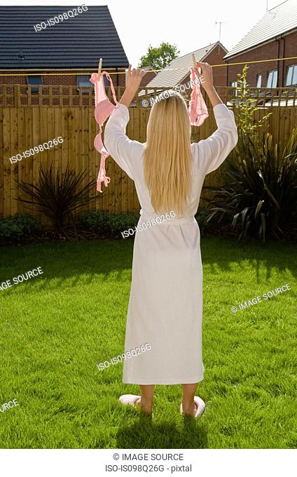 Woman putting lingerie in washing line