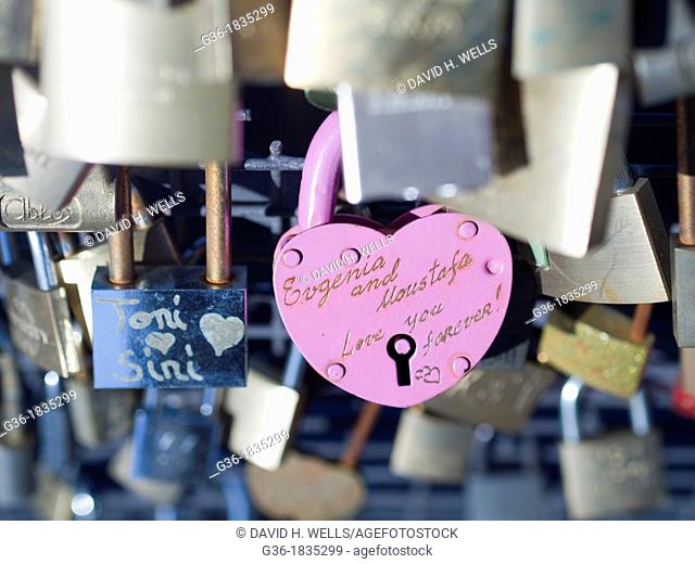 Locks left by romancing couples attached to bridge in accordance with local custom in Helsinki, Finland