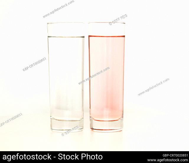 Two glasses of rose and transparent liquid on white background, São Paulo, Brazil