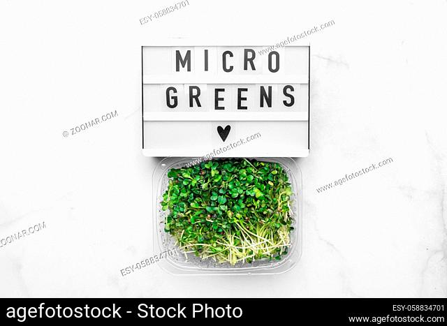 Top view of microgreens on white marble table. Healthy superfood concept. High quality photo
