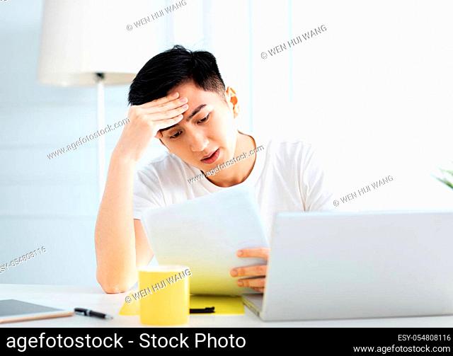 young man working at home with laptop
