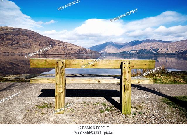 United Kingdom, Scotland, view of a loch, empty wooden bench