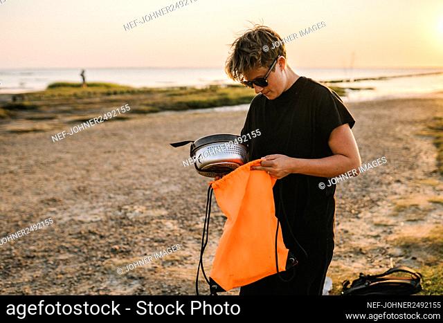 Woman holding dishes at beach