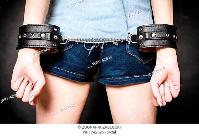 Arrest. Leather handcuffs on hands prisoner girl