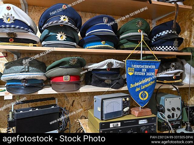 PRODUCTION - 19 January 2023, Brandenburg, Eggersdorf: Various headgear of uniforms can be seen in the museum of collector Christian Paul