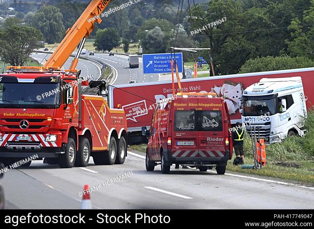 Recovery of a truck after an accident on the A8 motorway near Bernau am Chiemsee, a recovery crane with a cable winch pulls a truck that has left the roadway...