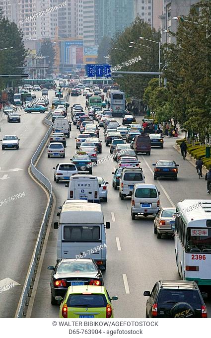 China. Yunnan Province. Kunming: Rush Hour Traffic along along Dongfeng Donglu / Dusk