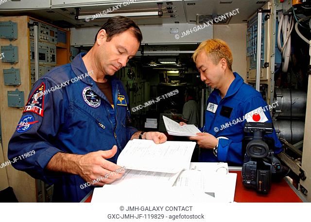 Astronaut Michael E. Lopez-Alegria (left), Expedition 14 commander and NASA space station science officer, and spaceflight participant Daisuke Enomoto...