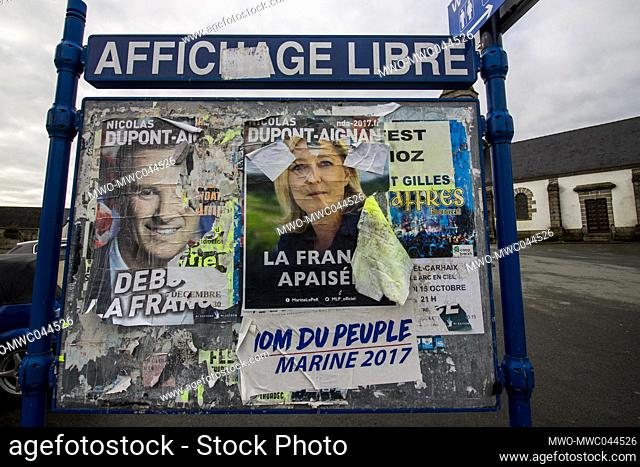 Posters of presidential candidates torn in a rural commune. Torn posters of Marine Le Pen and Nicolas Dupont Aignan. France