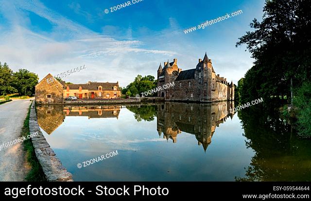 Campeneac, Brittany / France - 26 August 2019: view of the historic Chateau Trecesson castle in the Broceliande Forest with reflections in the pond