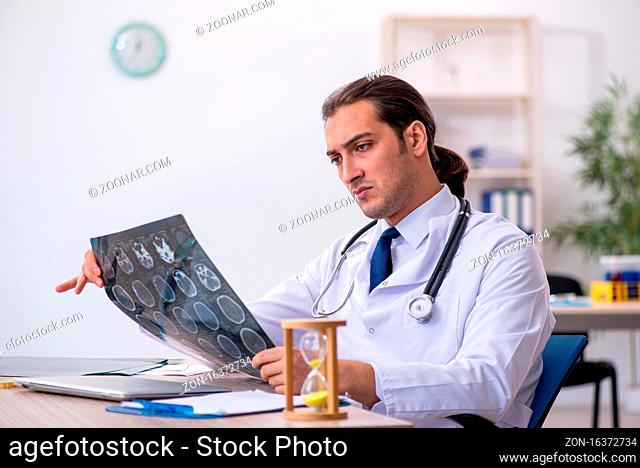 Young doctor in time management concept