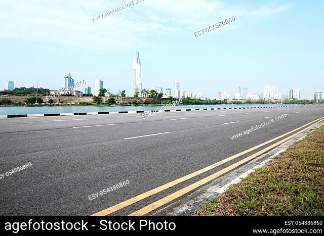 empty asphalt road and cityscape of nanjing in blue sky