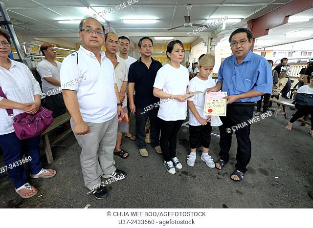 Widow donates money to Sarawak Chai's Clan Association. Sarawakian chinese funeral ceremony. Malaysia