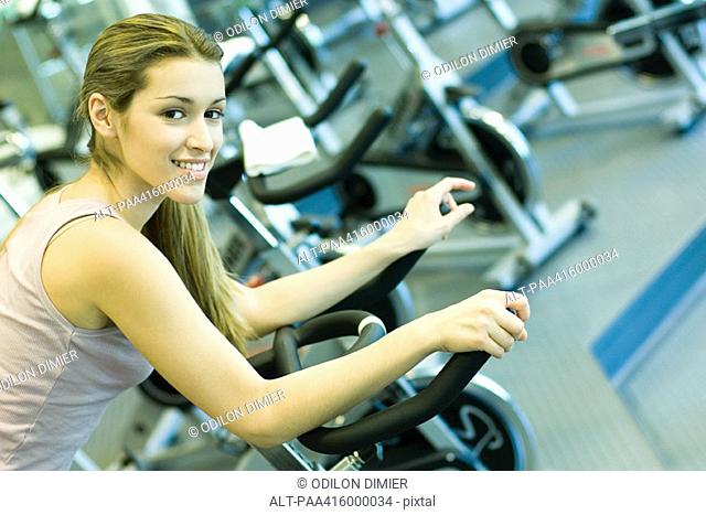 Woman riding exercise bike