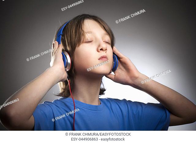 Boy with Brown Hair Listening to Music in Headphones