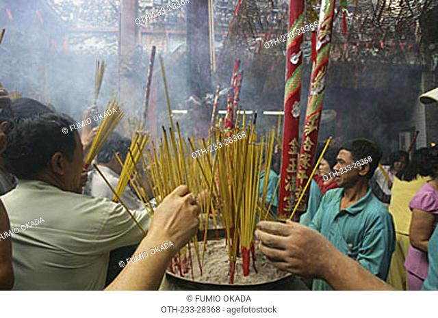 Devotee at Chua Ba Thien Hau, Nguyen Trai St, during the Chinese New Year, Ho Chi Minh City, Vietnam