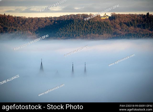 18 March 2023, Rhineland-Palatinate, Trier: The spires of Trier Cathedral and the Church of Our Lady rise out of the fog that lies over parts of the city