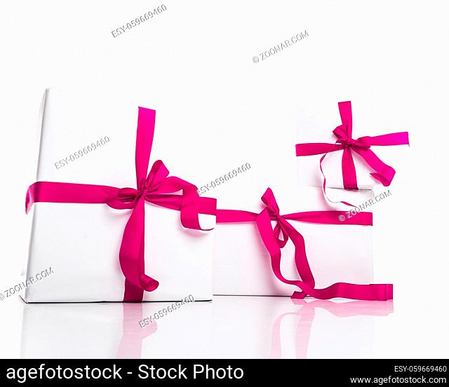 christmas white gift box with nice violet ribbon