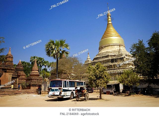 Bus in front of pagoda, Gubyaukgyi Temple, Bagan, Myanmar