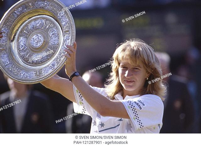 Steffi GRAF turns fifty years old on June 14, 2019, Steffi GRAF, Germany, holds the winners' cup, after her first Wimbledon victory, award ceremony
