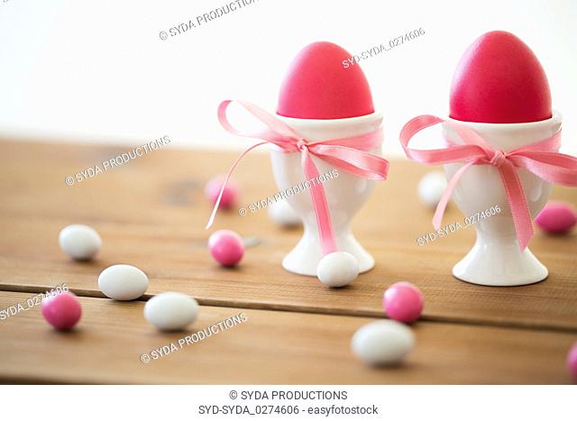 easter eggs in holders and candy drops on table