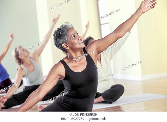 Older women stretching in yoga class