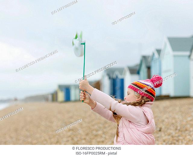 young Girl with Windmill on Beach