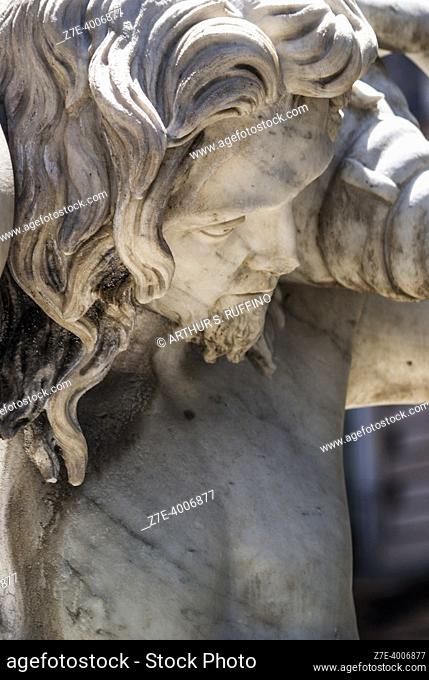 Detail, one of two fountain tritons. Amenano Fountain, Piazza Duomo, Metropolitan City of Catania, Sicily, Italy