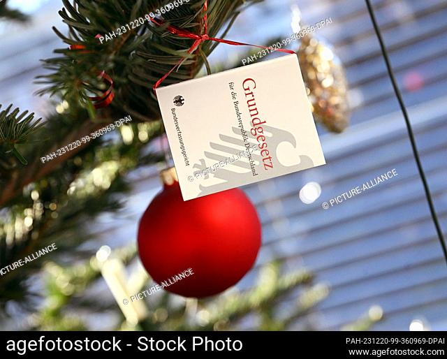 20 December 2023, Baden-Württemberg, Karlsruhe: A miniature version of the Basic Law hangs on a Christmas tree in the Federal Constitutional Court