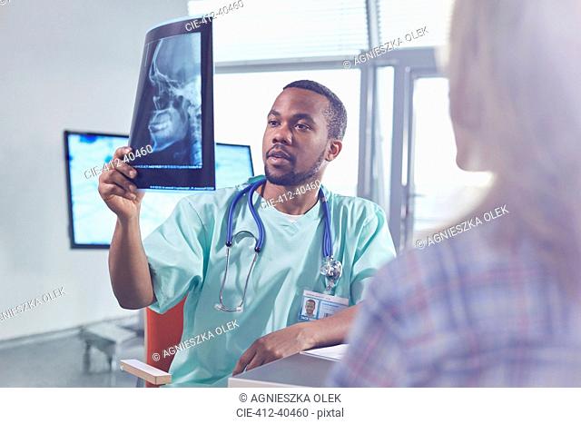 Male surgeon examining skull x-ray in hospital