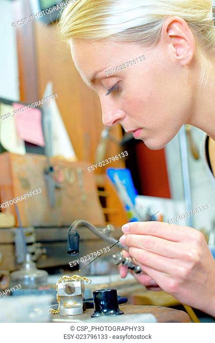Jeweler repairing chain