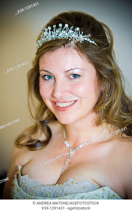 Portrait of young happy bride wearing tiara
