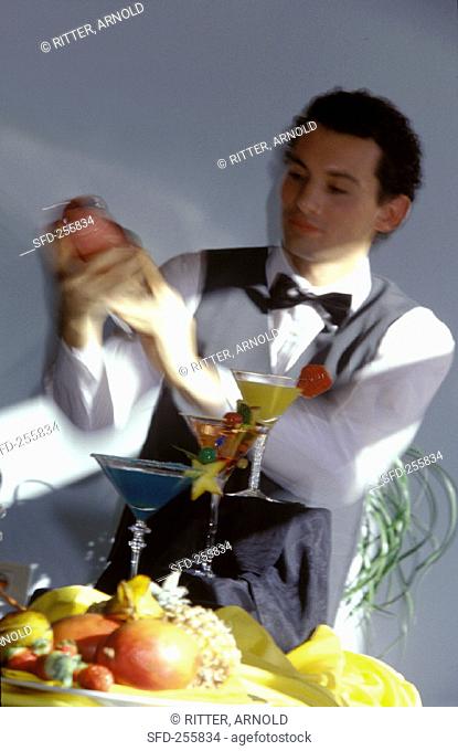 Waiter shaking a cocktail