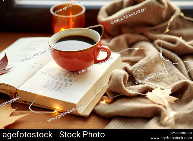 cup of coffee, book on window sill in autumn