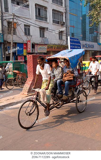 Cycle rickshaw carrying passengers in New Delhi, India