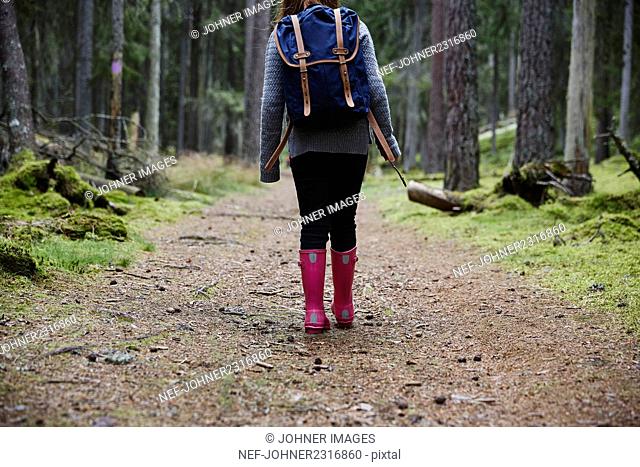 Girl walking in forest