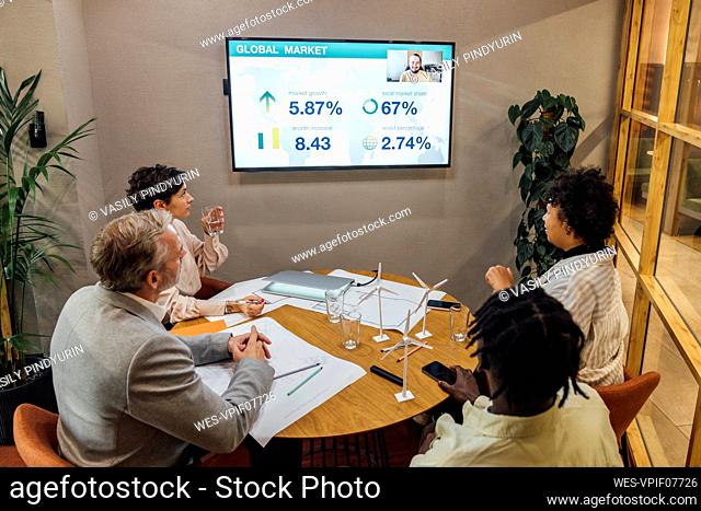 Businessman with colleagues having video conferencing in office