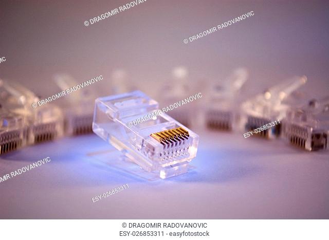Group of RJ-45 connectors on white background, Connectors are translucent and collored with blue light