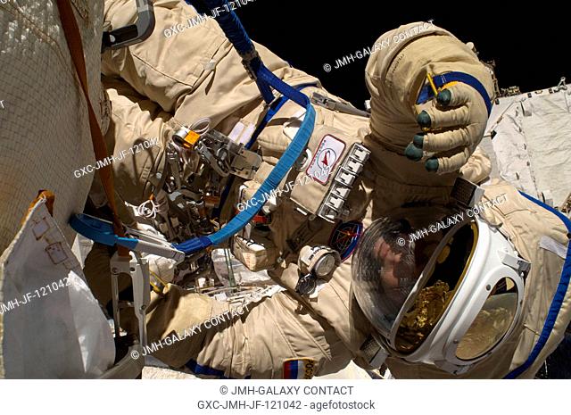 Russian cosmonauts Maxim Suraev and Oleg Kotov (out of frame), both Expedition 22 flight engineers, participate in a session of extravehicular activity (EVA) as...
